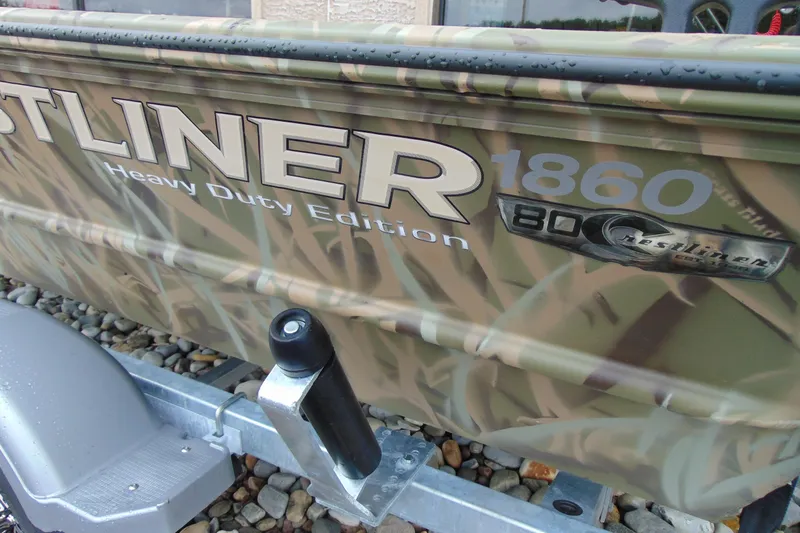 Slide: The Image of 2026 CRESTLINIER 1860 Retriever Deluxe Tiller boat with camouflage design on trailer. - 15