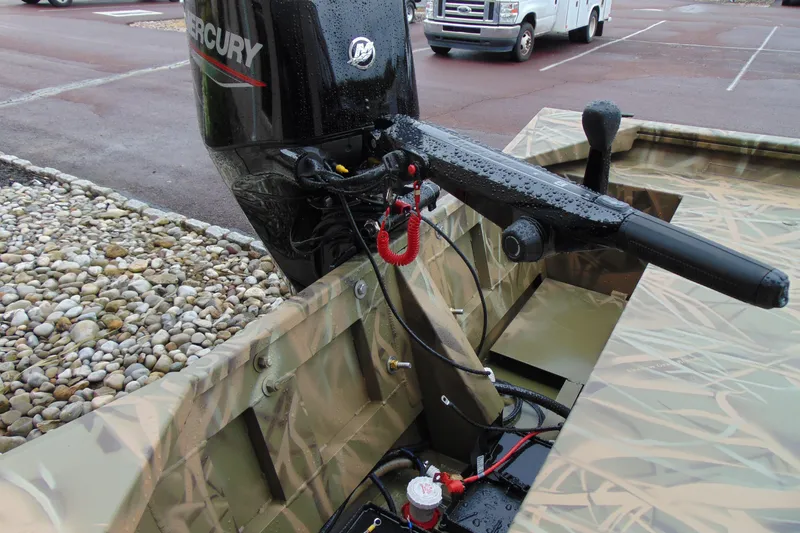 Slide: The Image of 2026 CRESTLINIER 1860 Retriever Deluxe Tiller with Mercury outboard motor in parking lot. - 8