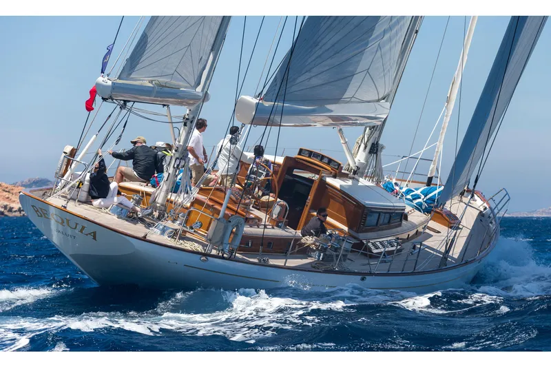 Slide: The Image of Sailing yacht by Brooklin Boat Yard, 2009 model, cruising on open sea with scenic coastline. - 0