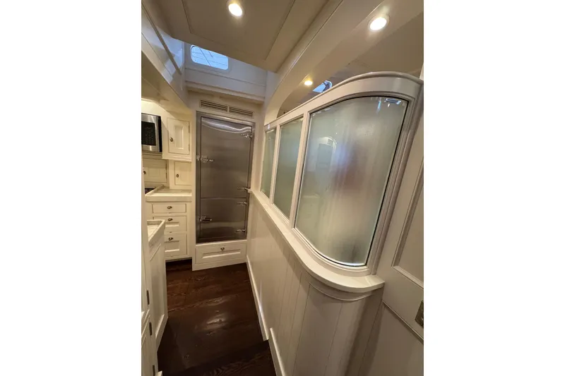 Slide: The Image of Luxurious yacht kitchen with modern appliances, marble countertops, and sleek cabinetry, Brooklin Boat Yard 2009. - 26