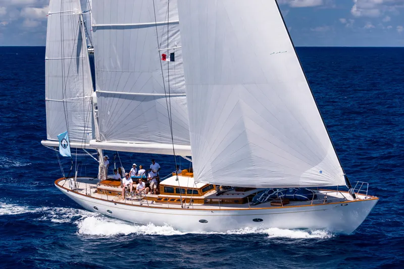 Slide: The Image of Crew adjusting sails on a 2009 Brooklin Boat Yard yacht in open water. - 32