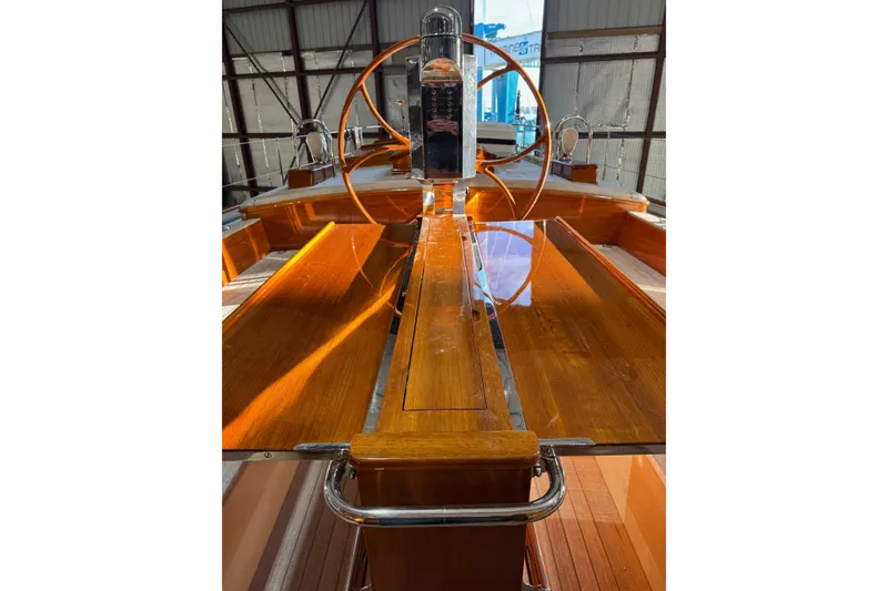 Slide: The Image of 2009 Brooklin Boat Yard model with polished wooden deck and steering wheel in a boatyard. - 37