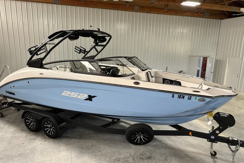 Slide: The Image of 2024 Yamaha Boats 252XE in a showroom, featuring sleek design and modern features. - 1