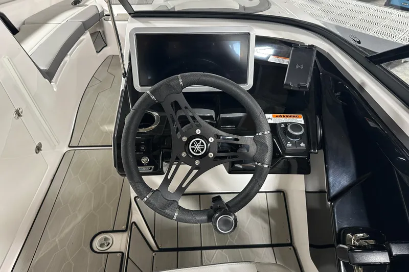 Slide: The Image of 2024 Yamaha Boats 252XE cockpit with steering wheel and modern dashboard controls. - 10