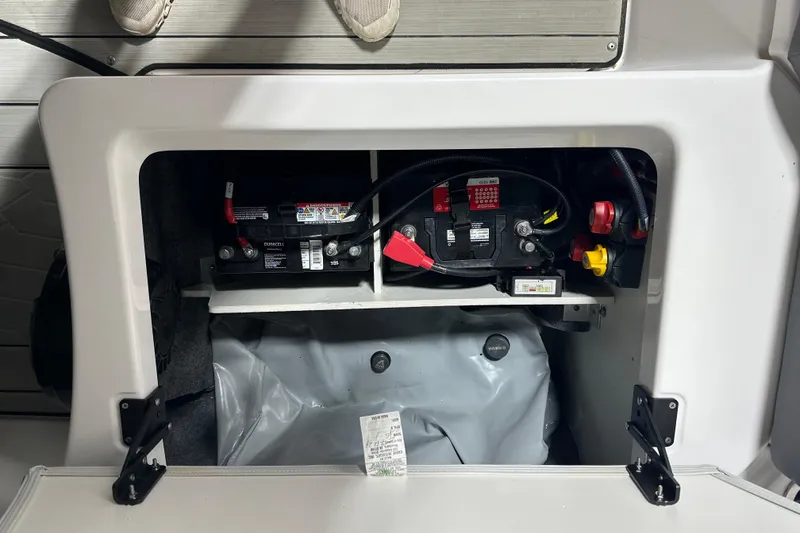 Slide: The Image of 2024 Yamaha Boats 252XE battery compartment with visible wiring and components. - 11