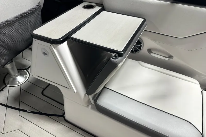 Slide: The Image of 2024 Yamaha Boats 252XE interior seating with table and cup holder. - 12