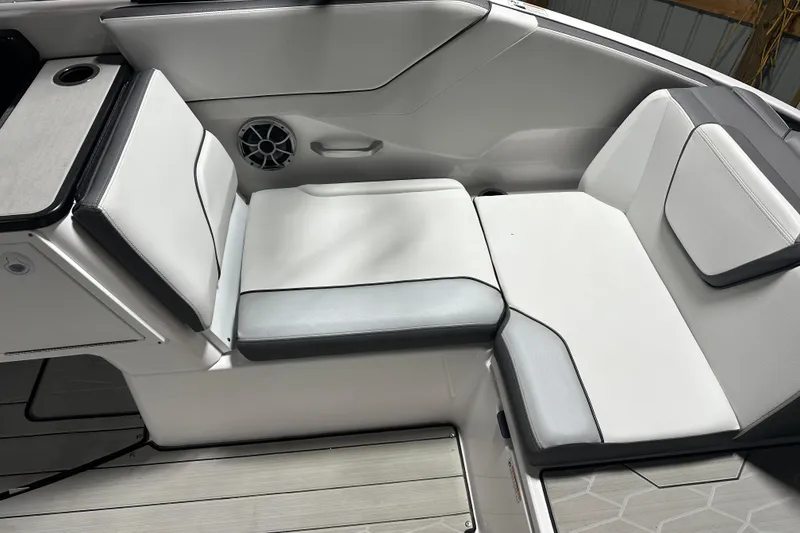 Slide: The Image of 2024 Yamaha Boats 252XE interior seating with sleek white and gray upholstery. - 13