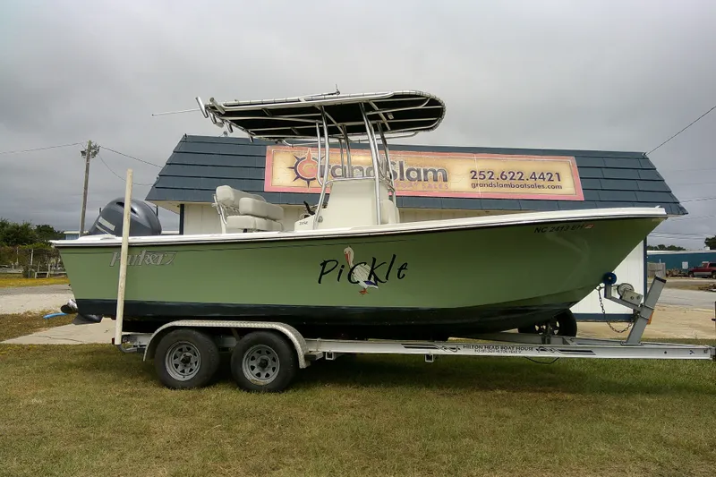 The Image of 2016 Parker 2100 Special Edition boat on trailer, displayed outdoors near a sales building. - 1