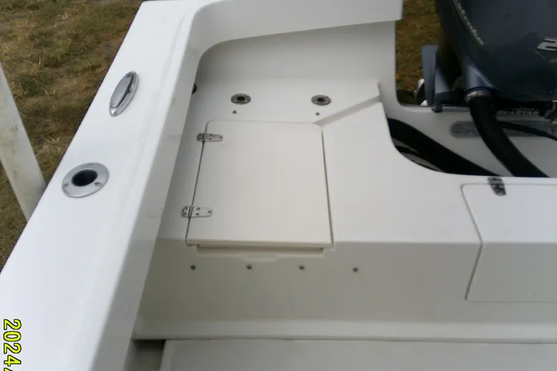 Slide: The Image of 2016 Parker 2100 Special Edition boat interior with storage compartment and motor detail. - 21