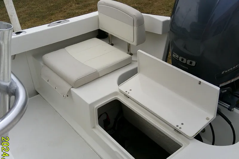 Slide: The Image of 2016 Parker 2100 Special Edition boat interior with Yamaha 200 engine and storage compartment. - 32