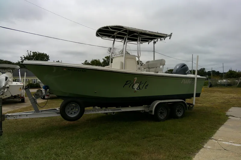 Slide: The Image of 2016 Parker 2100 Special Edition boat on trailer, green hull, parked outdoors. - 4