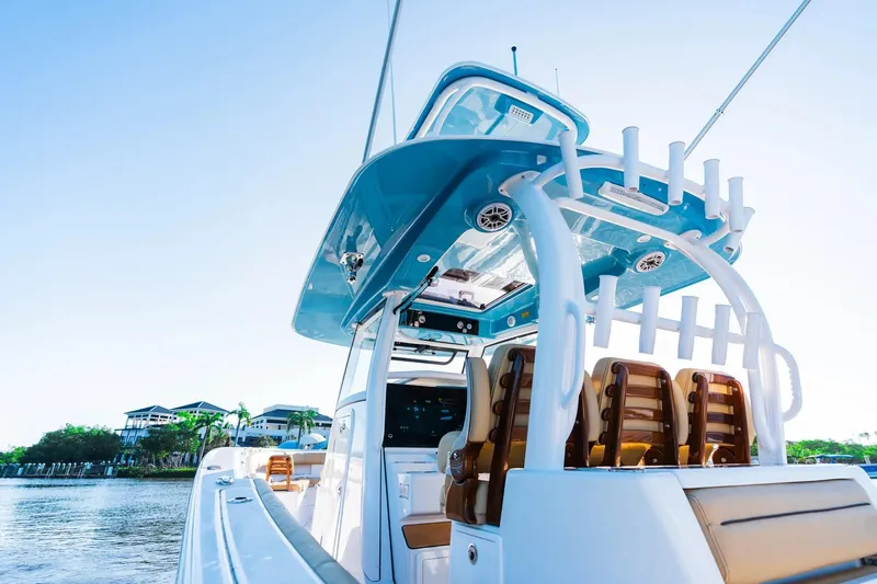 Slide: The Image of 2026 Sportsman Open 352 Center Console boat on calm water, showcasing sleek design. - 11