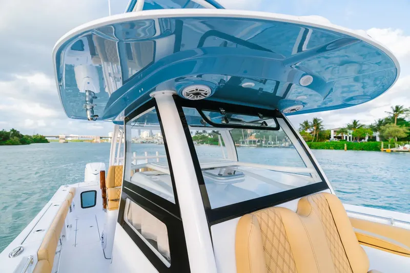 Slide: The Image of 2026 Sportsman Open 352 Center Console boat on water, featuring sleek design and luxurious seating. - 12