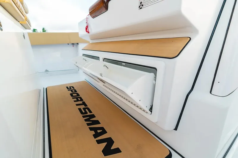 Slide: The Image of 2026 Sportsman Open 352 Center Console boat interior with branded flooring and storage compartments. - 15