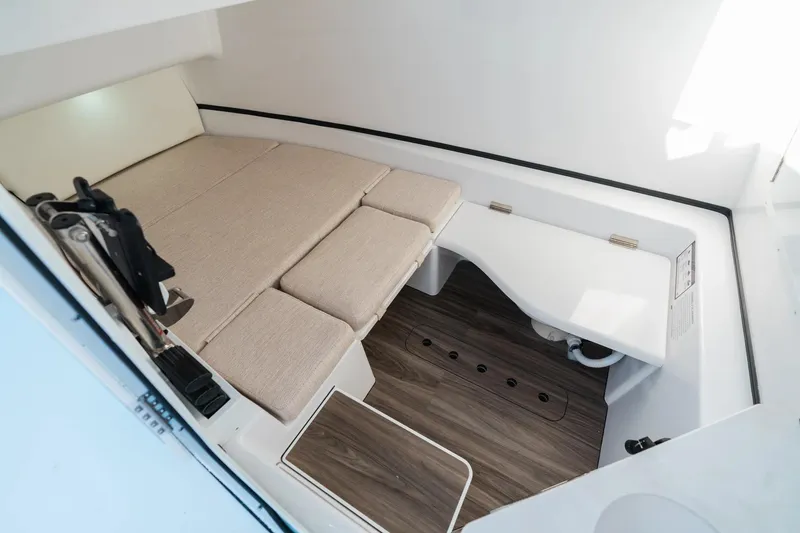 Slide: The Image of 2026 Sportsman Open 352 Center Console cabin interior with cushioned seating and wood flooring. - 17