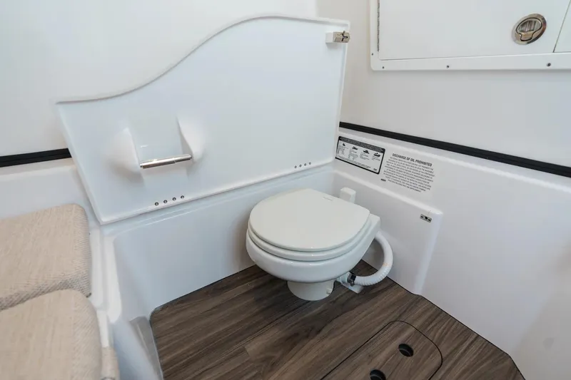 Slide: The Image of 2026 Sportsman Open 352 Center Console boat interior with modern marine toilet. - 21
