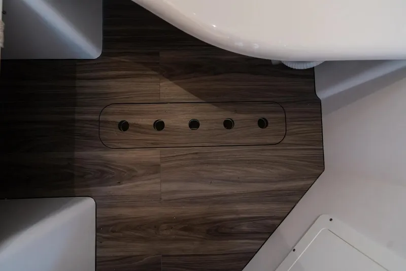 Slide: The Image of 2026 Sportsman Open 352 Center Console interior with wood flooring and drainage holes. - 23