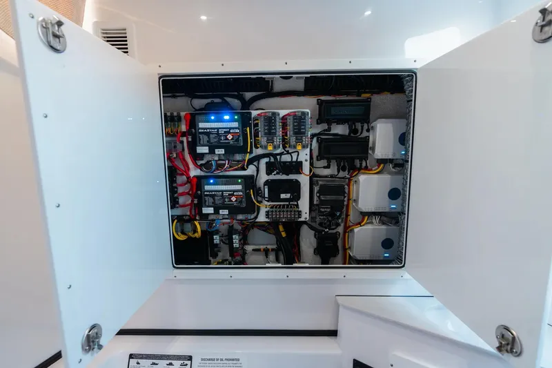 Slide: The Image of Electrical panel inside 2026 Sportsman Open 352 Center Console boat, showcasing wiring and components. - 24