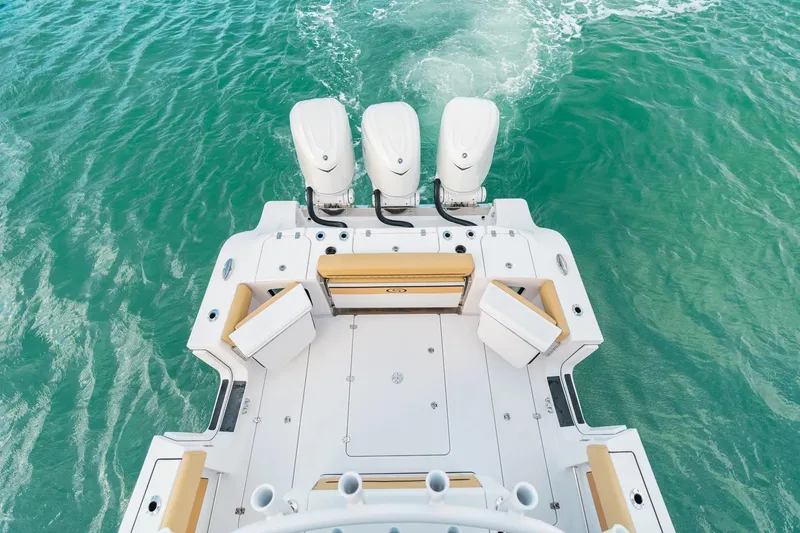 Slide: The Image of 2026 Sportsman Open 352 Center Console boat on turquoise water, featuring triple engines. - 27