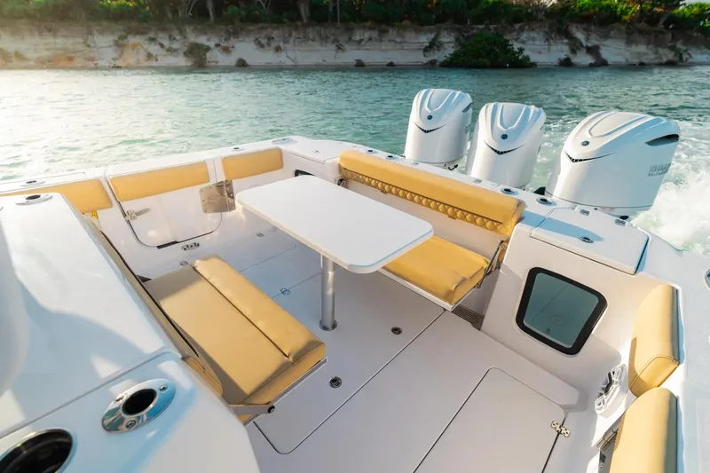 Slide: The Image of 2026 Sportsman Open 352 Center Console boat with seating and table on deck. - 28