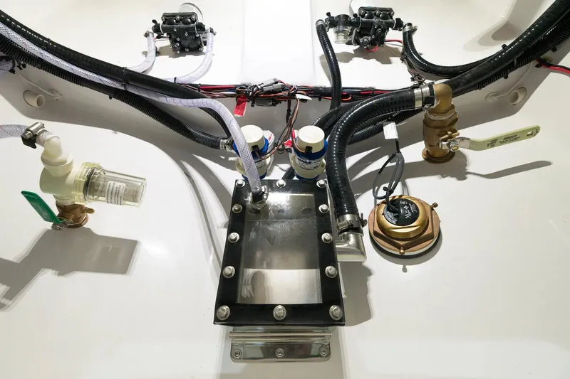 Slide: The Image of 2026 Sportsman Open 352 Center Console boat engine compartment with hoses and valves. - 29