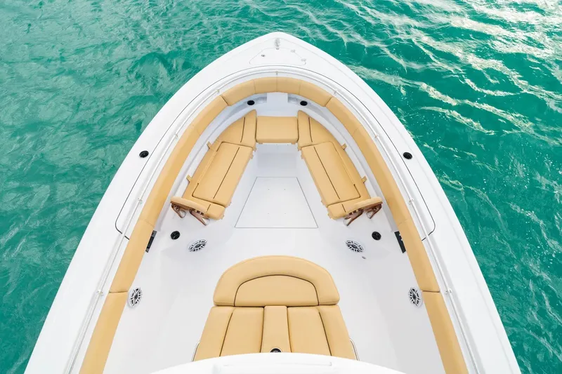 Slide: The Image of 2026 Sportsman Open 352 Center Console boat with tan seating on turquoise water. - 3