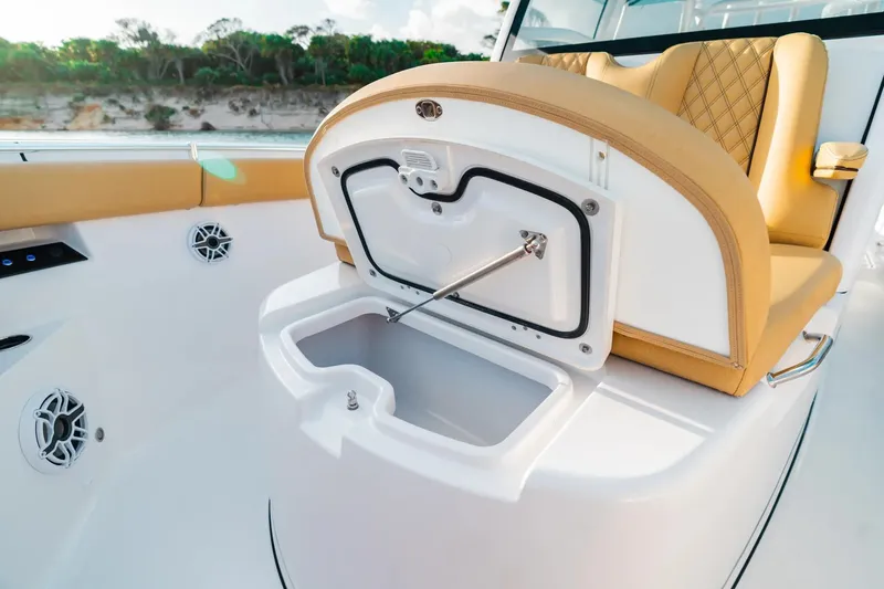 Slide: The Image of 2026 Sportsman Open 352 Center Console with open storage compartment and tan seating. - 7