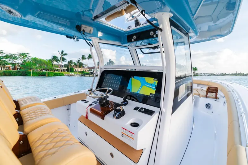 Slide: The Image of 2026 Sportsman Open 352 Center Console boat interior with navigation system and luxurious seating. - 9