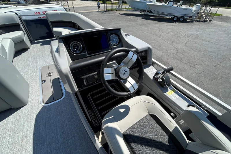 Slide: The Image of 2026 Harris FloteBote 250 Solstice SLDH boat interior with modern steering and dashboard. - 15