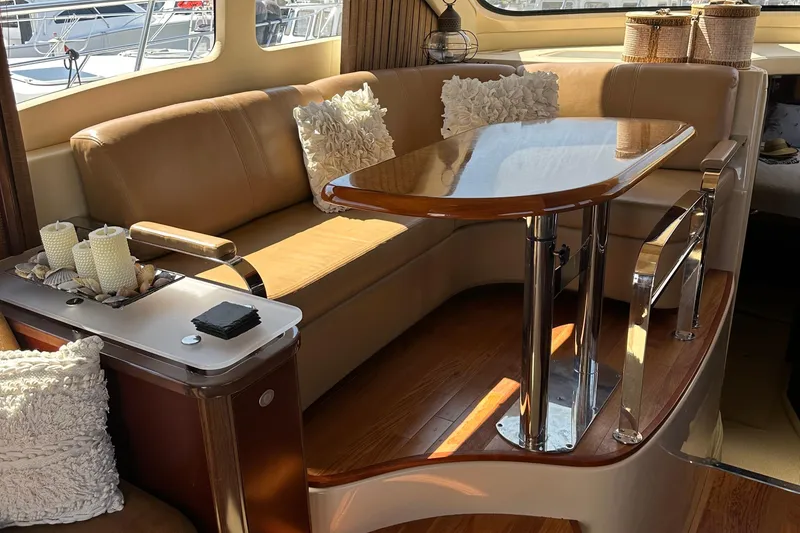 Slide: The Image of Luxurious interior of 2005 Sea Ray 500 Sedan Bridge with elegant seating and table. - 12