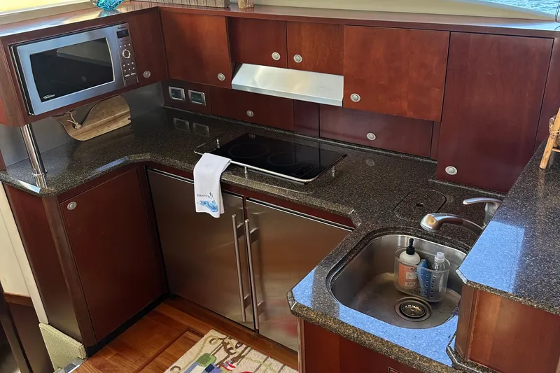 Slide: The Image of Luxurious kitchen in 2005 Sea Ray 500 Sedan Bridge yacht with modern appliances. - 13