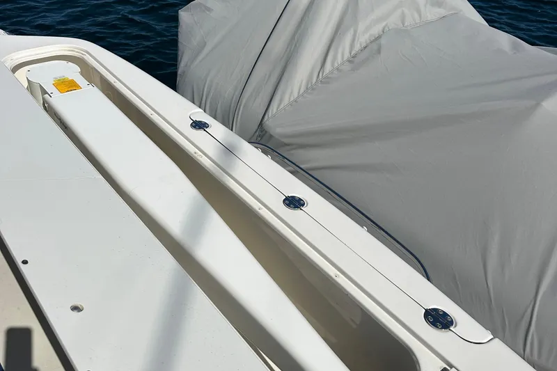 Slide: The Image of 2005 Sea Ray 500 Sedan Bridge deck with covered equipment, near water. - 14