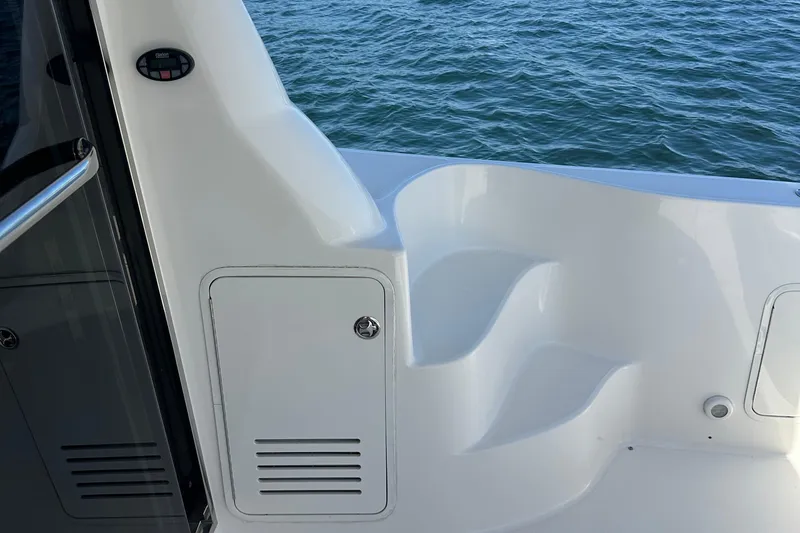 Slide: The Image of 2005 Sea Ray 500 Sedan Bridge boat deck with white seating and ocean view. - 16