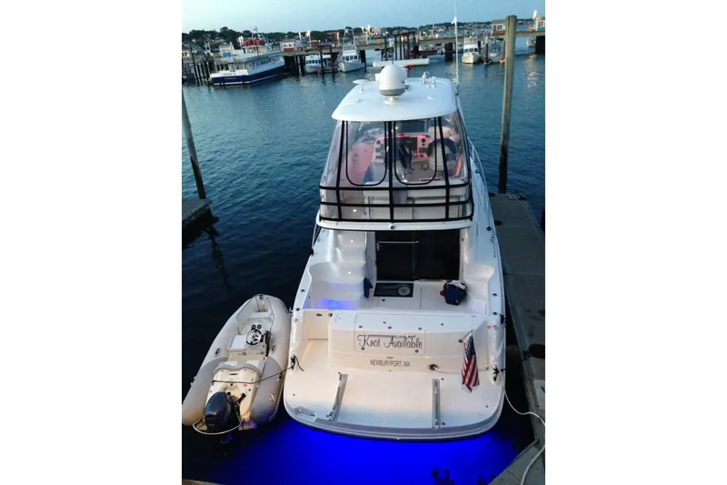 Slide: The Image of 2005 Sea Ray 500 Sedan Bridge yacht docked with blue underwater lights. - 2
