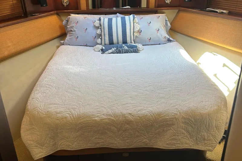 Slide: The Image of Cozy bedroom in 2005 Sea Ray 500 Sedan Bridge yacht with decorative pillows and quilt. - 23