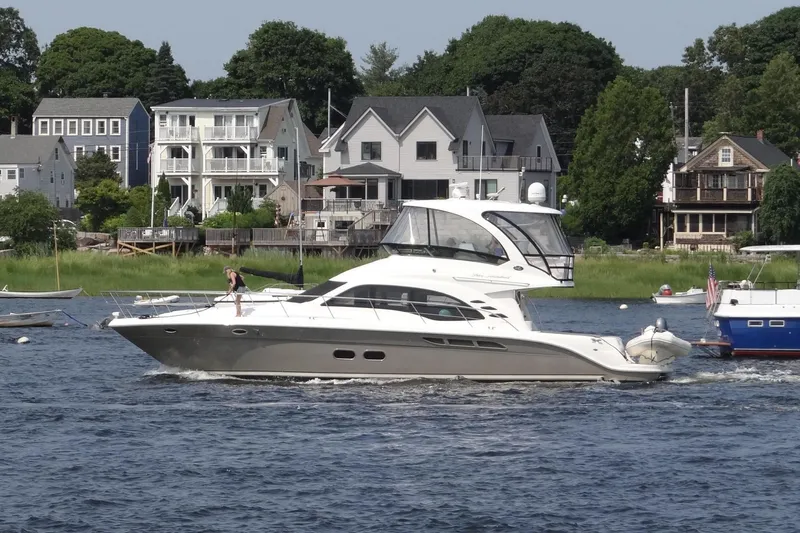 Slide: The Image of 2005 Sea Ray 500 Sedan Bridge yacht cruising near waterfront homes. - 28