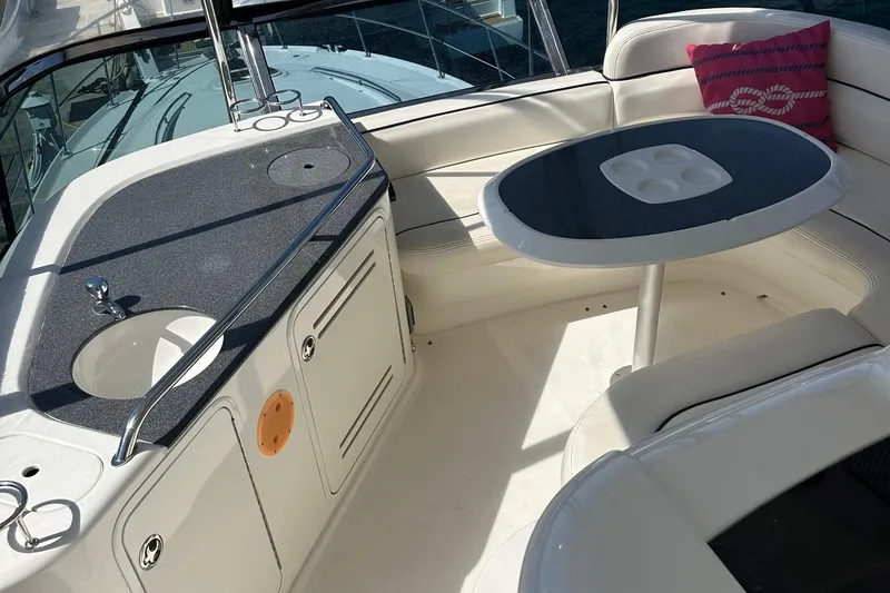 Slide: The Image of 2005 Sea Ray 500 Sedan Bridge interior with seating, table, and sink. - 7