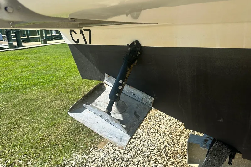Slide: The Image of 2006 Sea Ray 260 Sundancer trim tab detail on a grassy marina background. - 10