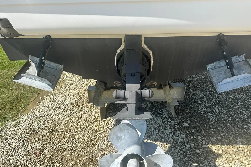 Slide: The Image of Rear view of 2006 Sea Ray 260 Sundancer boat showing propeller and trim tabs. - 12