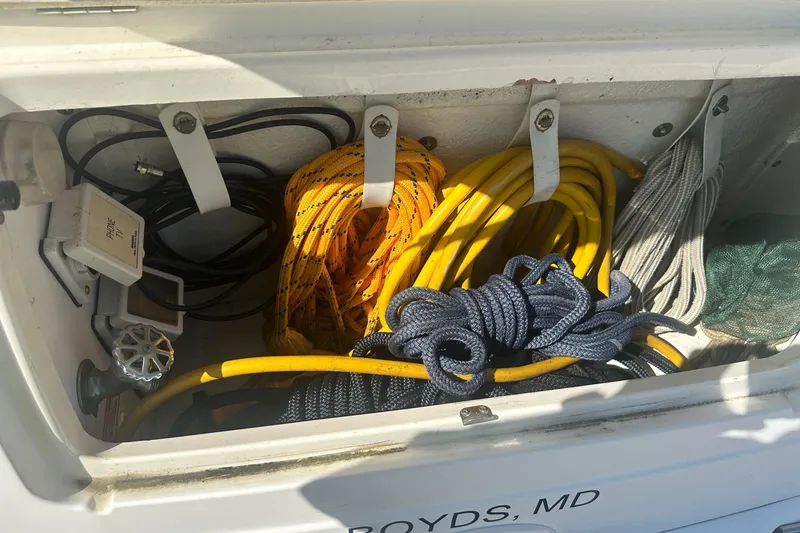 Slide: The Image of Storage compartment of a 2006 Sea Ray 260 Sundancer with ropes and cables. - 15