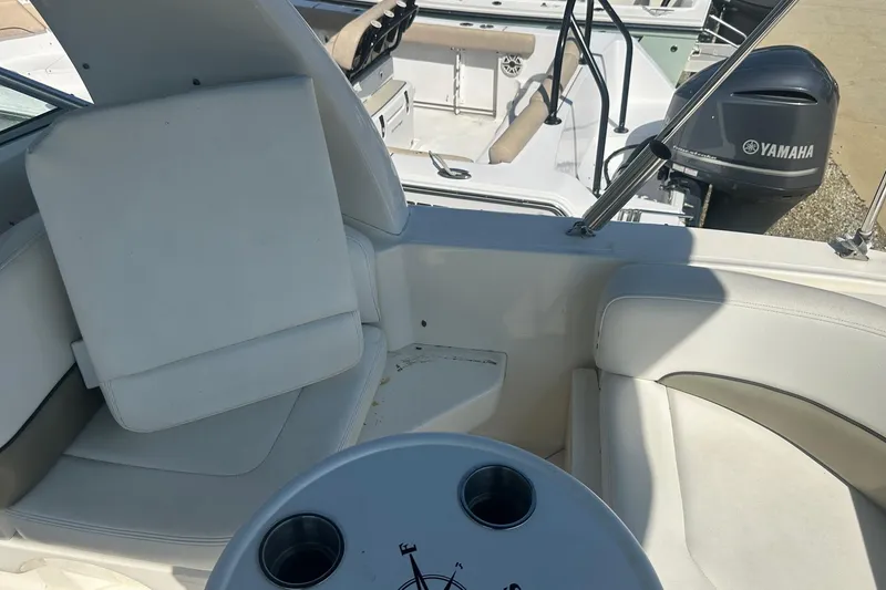 Slide: The Image of 2006 Sea Ray 260 Sundancer interior with seating and Yamaha engine in view. - 21