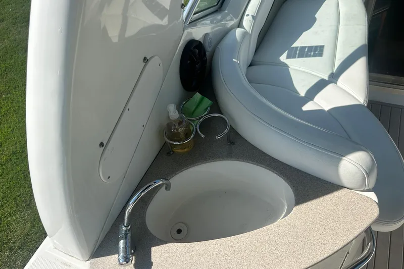 Slide: The Image of 2006 Sea Ray 260 Sundancer boat interior with sink and seating area. - 23