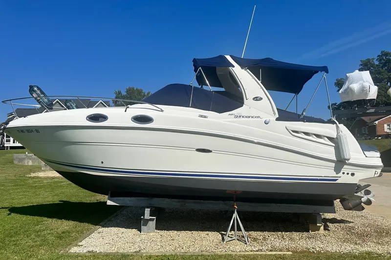Slide: The Image of 2006 Sea Ray 260 Sundancer boat on display under clear blue sky. - 3