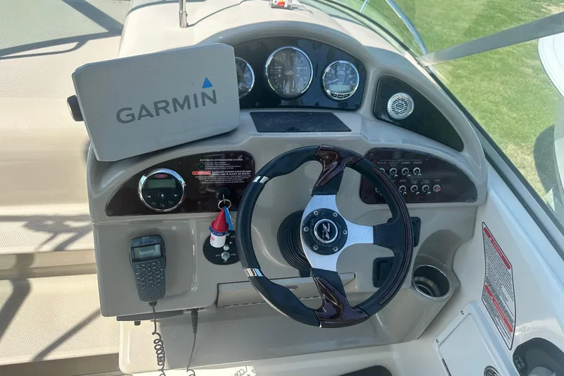 Slide: The Image of 2006 Sea Ray 260 Sundancer helm with Garmin GPS and marine radio. - 33
