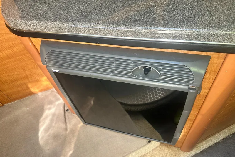 Slide: The Image of 2006 Sea Ray 260 Sundancer cabin interior with compact refrigerator. - 41