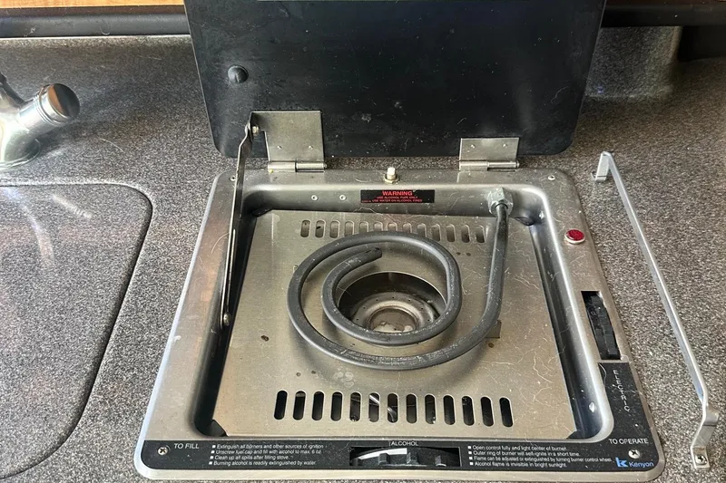 Slide: The Image of 2006 Sea Ray 260 Sundancer boat stove with coiled burner on countertop. - 47