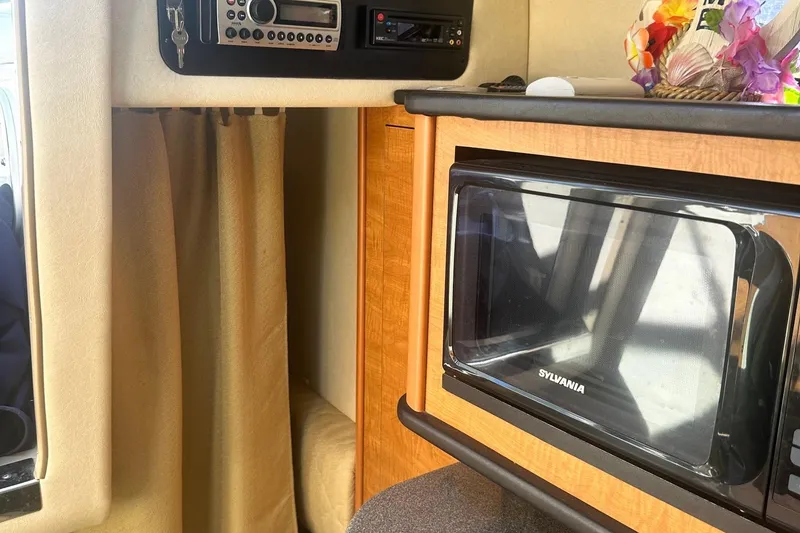 Slide: The Image of Interior of 2006 Sea Ray 260 Sundancer with microwave and stereo system. - 49