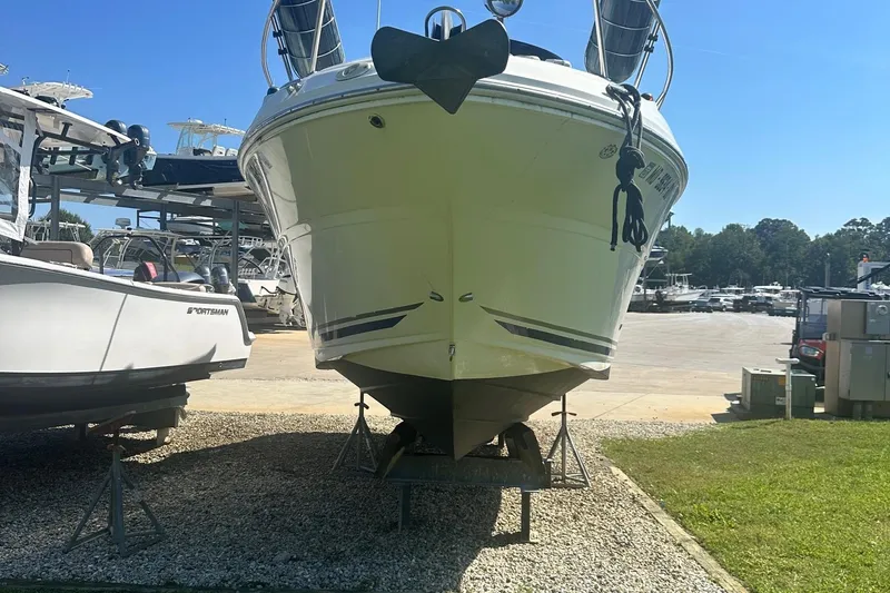 Slide: The Image of 2006 Sea Ray 260 Sundancer boat on dry dock, surrounded by other boats. - 5