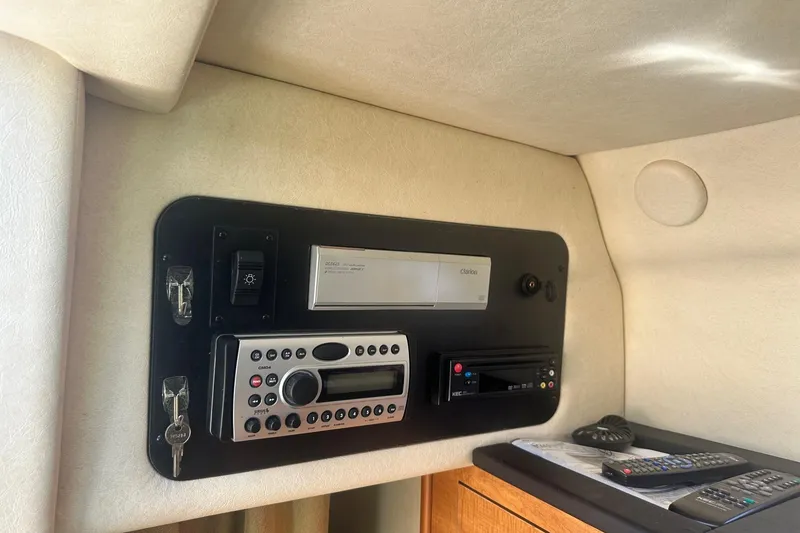 Slide: The Image of Control panel of a 2006 Sea Ray 260 Sundancer boat with audio system and remote controls. - 52