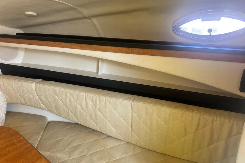 Slide: The Image of Interior cabin of 2006 Sea Ray 260 Sundancer with beige quilted seating. - 53